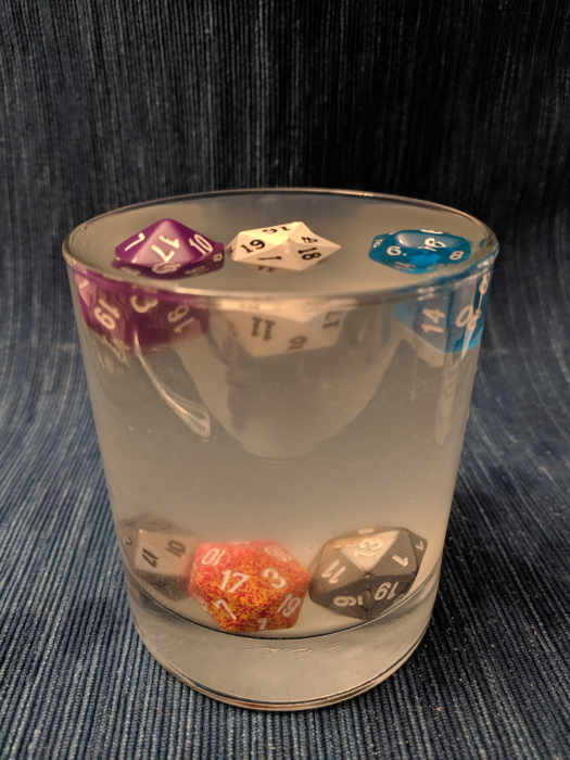 Dice in a glass of salt water, some floating