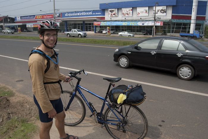 Micah with is bike on the outskirts of Ubon