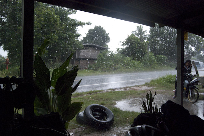 an afternoon rainstorm from under a restaurant's shelter