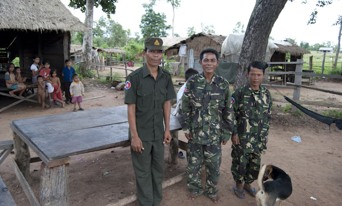 men in army fatigues with house and family