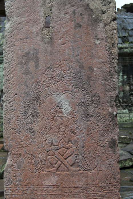 pillar carving with seated figure