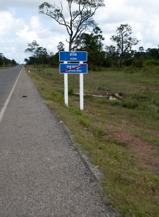 road sign with crossed-out location