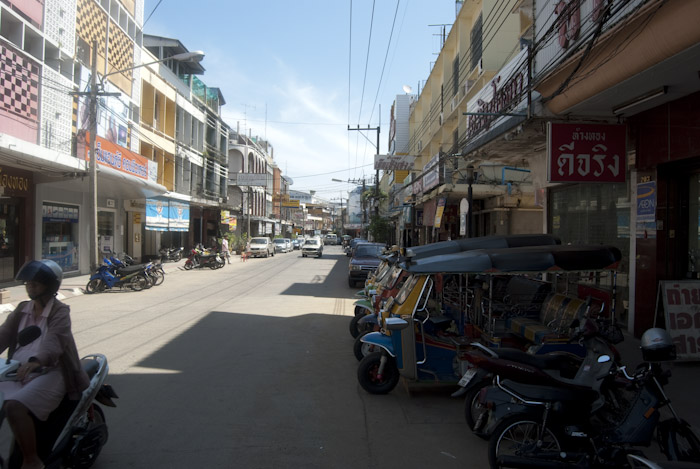 road with shops and vehicles