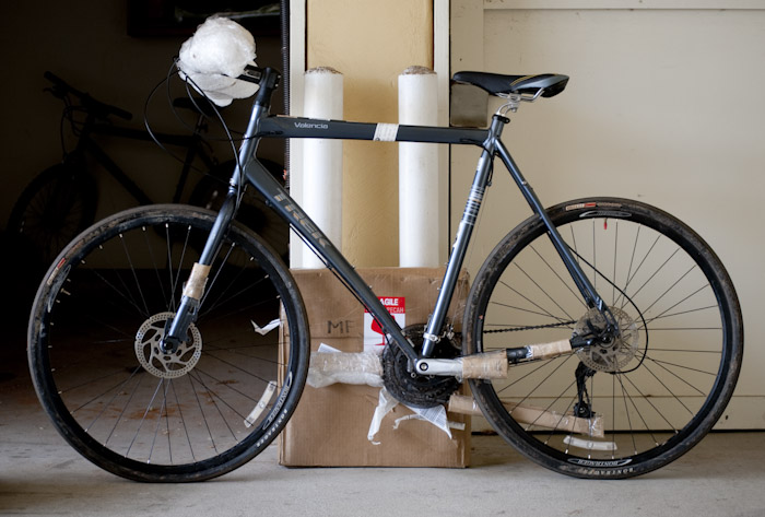 bicycle and box in front of garage