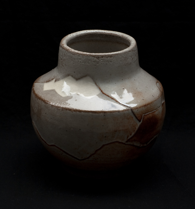 vase in low lighting with mountain releif